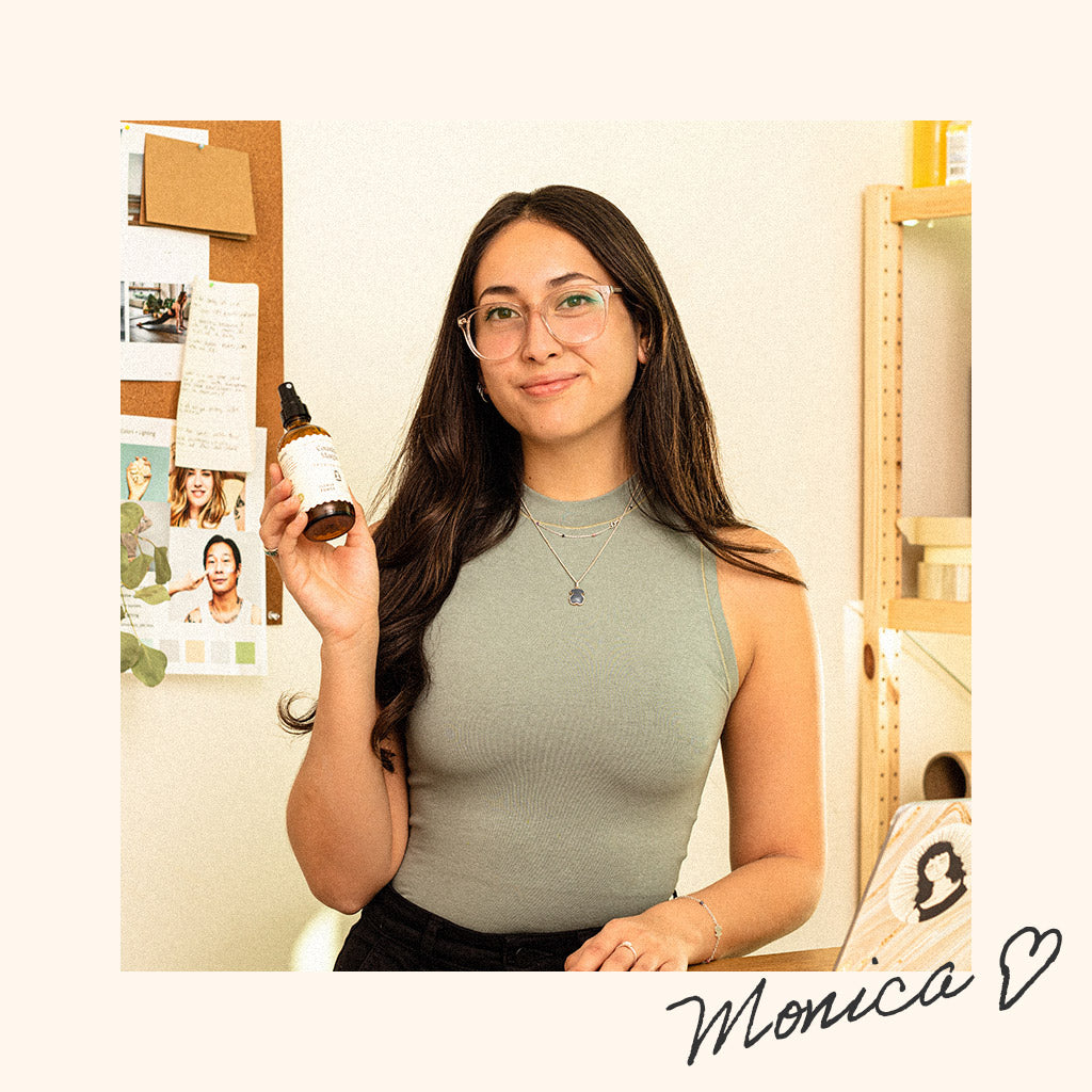 Cousin May's founder Monica proudly holds up a bottle in her small business headquarters.