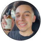 A reviewer smiles with his bottle of Cousin May's after leaving a good review.